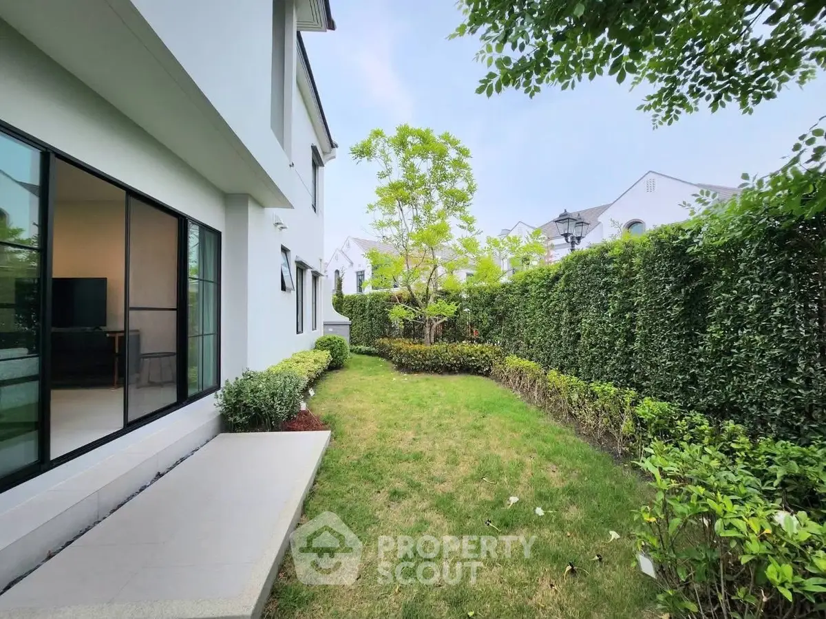 Charming garden view of modern home with lush greenery and spacious outdoor area.