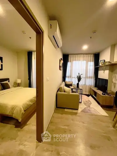 Modern apartment interior with cozy living room and stylish bedroom, featuring elegant decor and natural light.