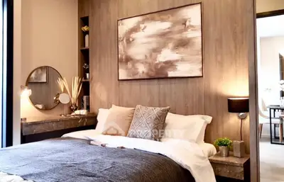 Elegant bedroom with a plush king-sized bed, modern art, and tasteful decor, exuding a serene and luxurious ambiance perfect for relaxation.