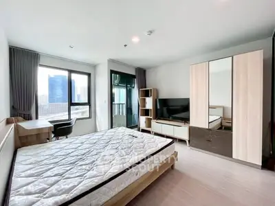 Spacious modern bedroom with city view, featuring a large bed, wardrobe, and TV setup.