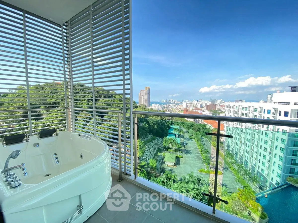 Luxurious balcony with jacuzzi and stunning city view in modern high-rise apartment.