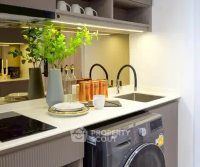 Modern kitchen with sleek design, featuring dual sinks and built-in appliances.