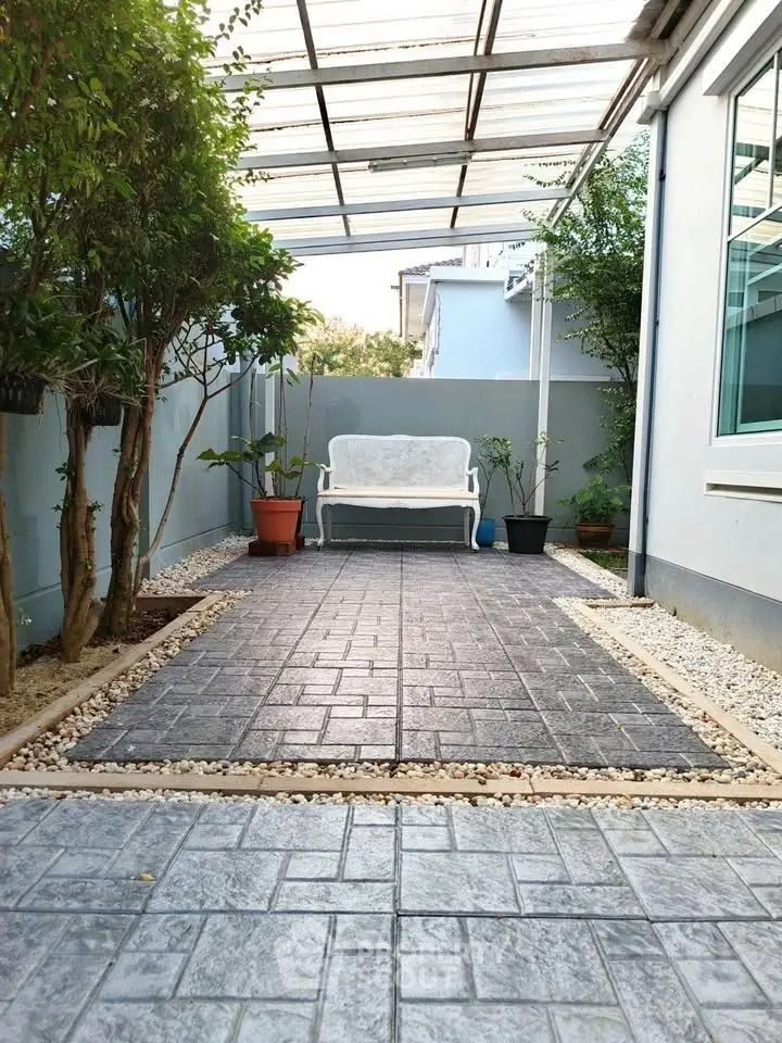 Charming outdoor patio with elegant paving and cozy seating area, perfect for relaxation and entertaining.