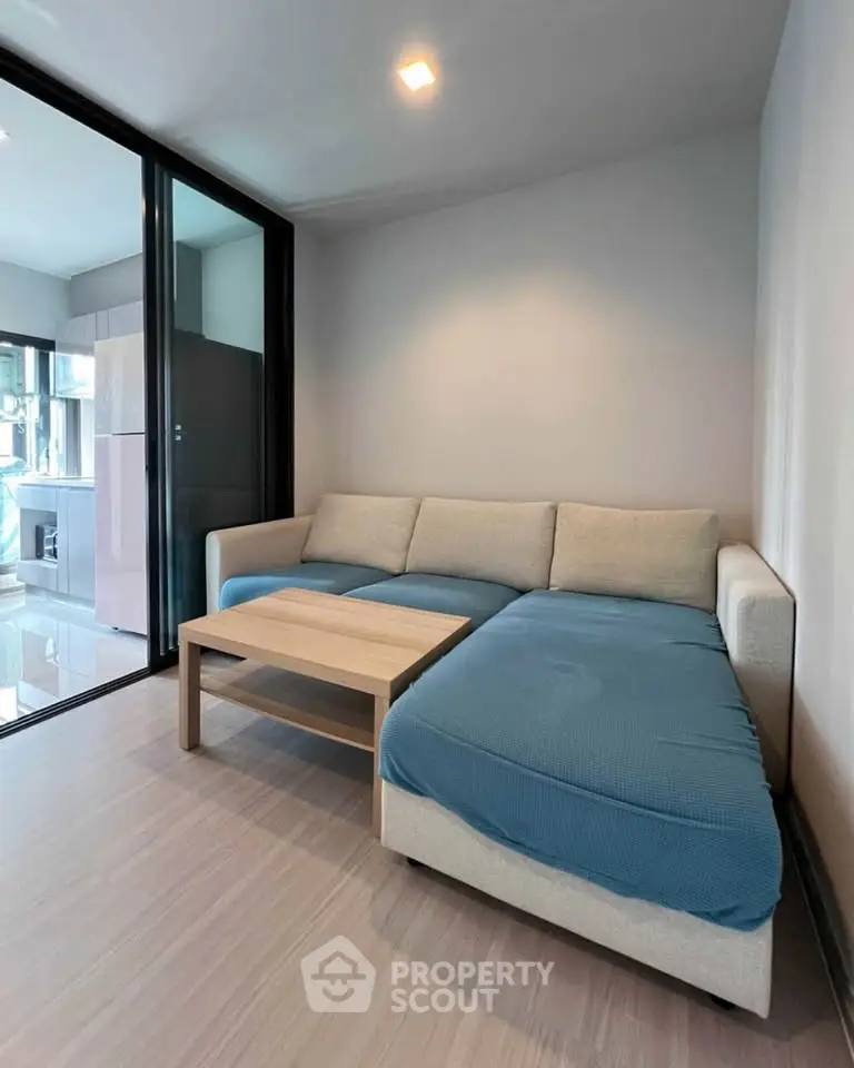 Modern living room with cozy sectional sofa and sleek glass partition