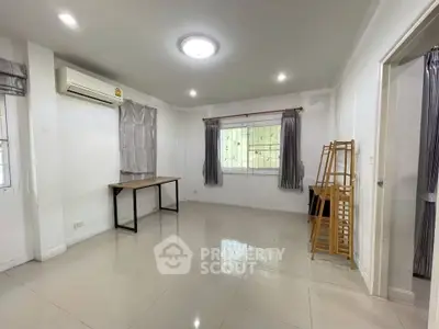 Spacious unfurnished room with air conditioning and large windows, perfect for customization.