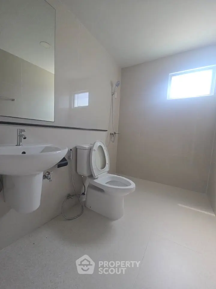 Spacious modern bathroom with sleek fixtures and natural light.