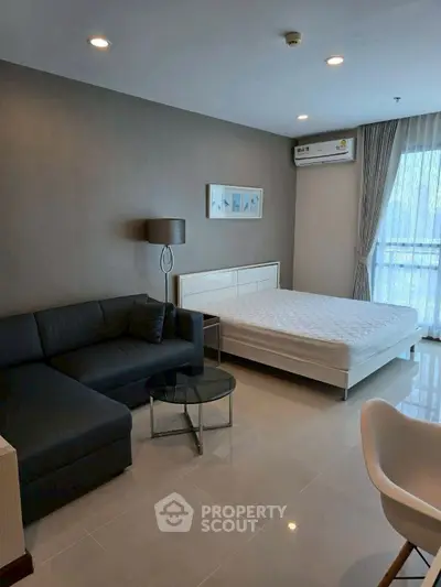 Modern studio apartment with sleek furnishings and natural light