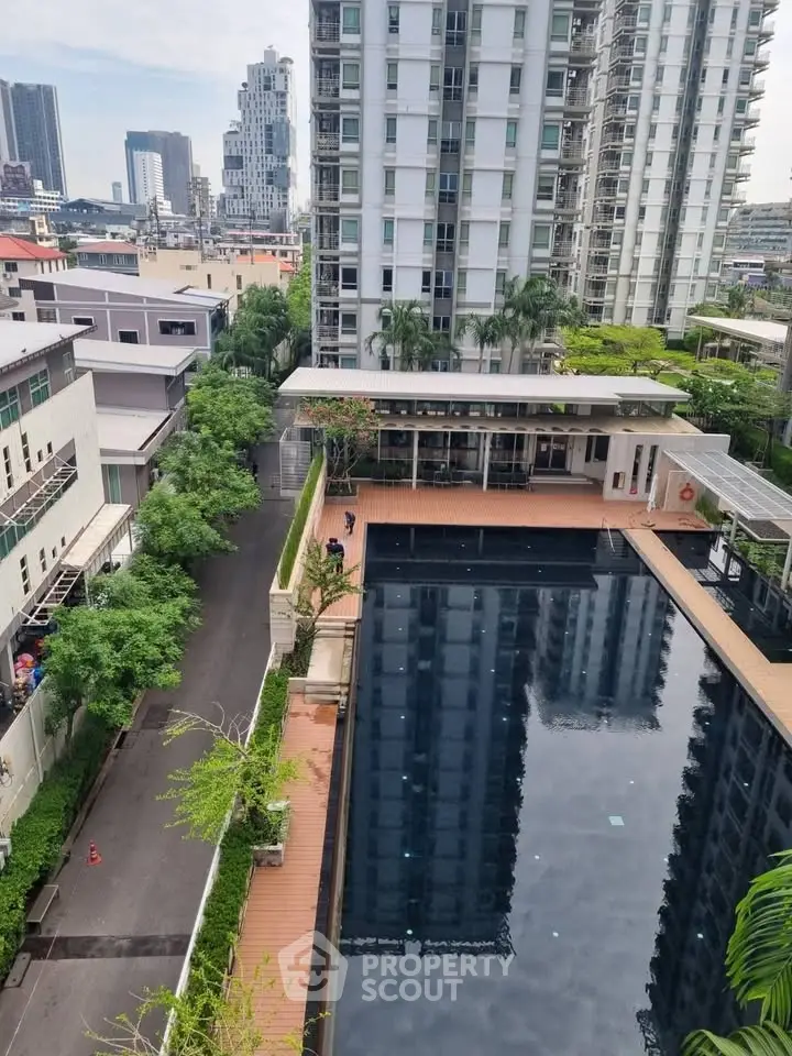 Stunning urban apartment complex with a large pool and city views, perfect for modern living.