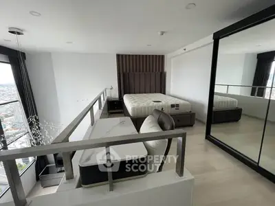Modern loft bedroom with city view, featuring a stylish bed and mirrored wardrobe.