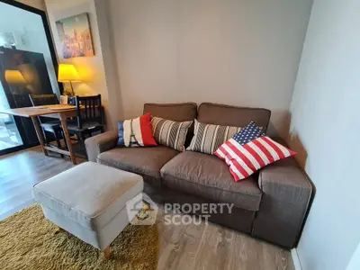 Cozy living room with stylish sofa and dining area, perfect for relaxation and entertaining.
