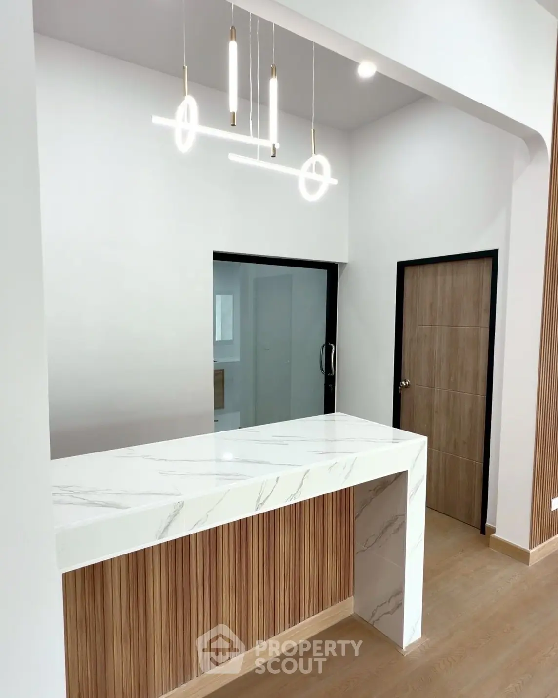 Modern interior with stylish lighting and marble countertop in a contemporary home setting.