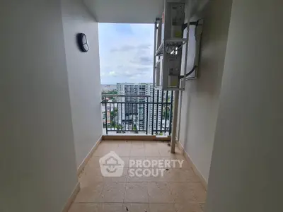 Spacious balcony with stunning city view in modern high-rise apartment.