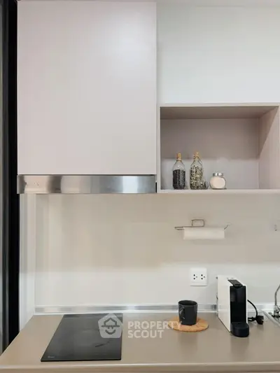 Modern kitchen with sleek induction cooktop and minimalist shelving