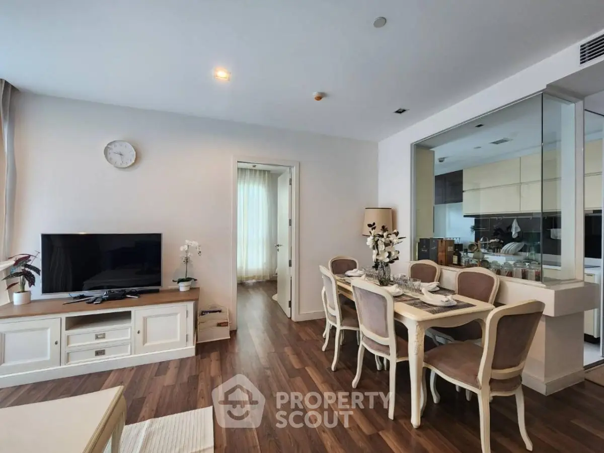 Elegant living room with dining area, featuring hardwood floors and modern decor, perfect for stylish urban living.