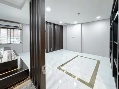 Spacious modern living room with elegant tile flooring and stylish partition design.