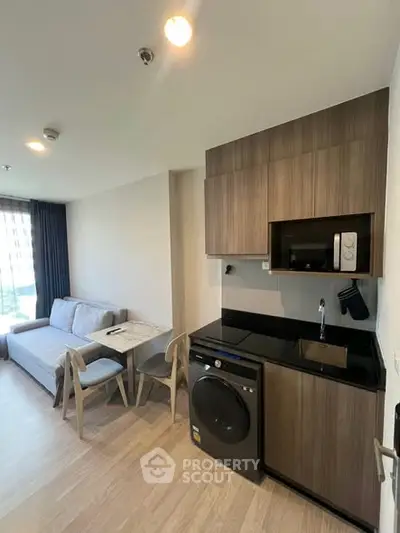 Modern compact living space with kitchen and cozy seating area