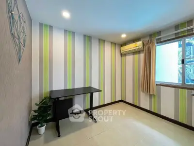 Bright study room with modern decor and air conditioning, perfect for productivity and comfort.