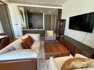 Modern living room with sleek furniture and open kitchen layout in luxury apartment.