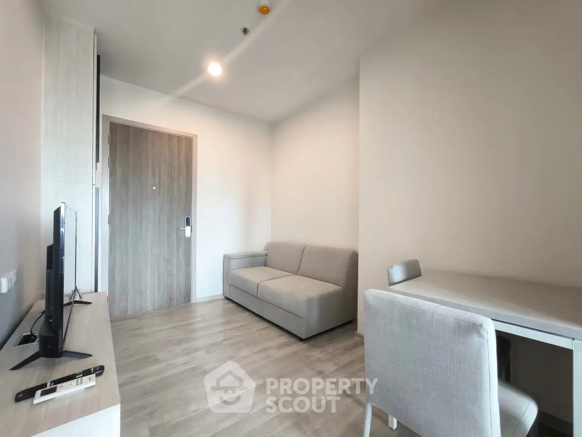 Modern living room with sleek furniture and neutral tones, perfect for a cozy urban lifestyle.