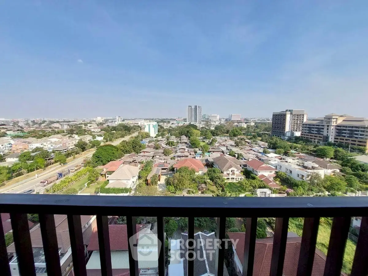 Stunning cityscape view from a high-rise balcony overlooking urban landscape and skyline.