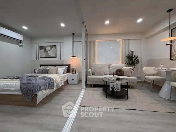 Modern studio apartment with stylish decor, featuring a cozy bed, elegant living area, and dining space.