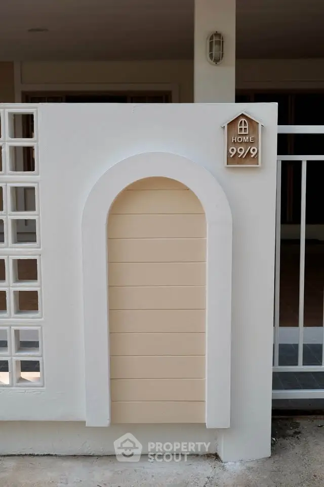 Charming home entrance with unique arched design and modern aesthetic, perfect for welcoming guests.