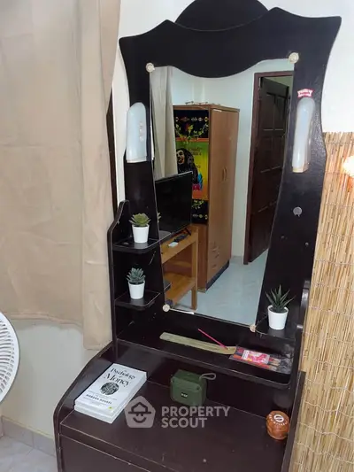 Cozy bedroom with a stylish vanity mirror and modern decor