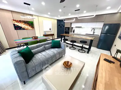 Modern open-plan living room with stylish kitchen and cozy seating area, perfect for entertaining.