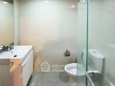 Modern bathroom with sleek fixtures and glass shower enclosure