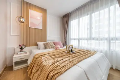 Cozy and stylish bedroom with modern decor and ample natural light.