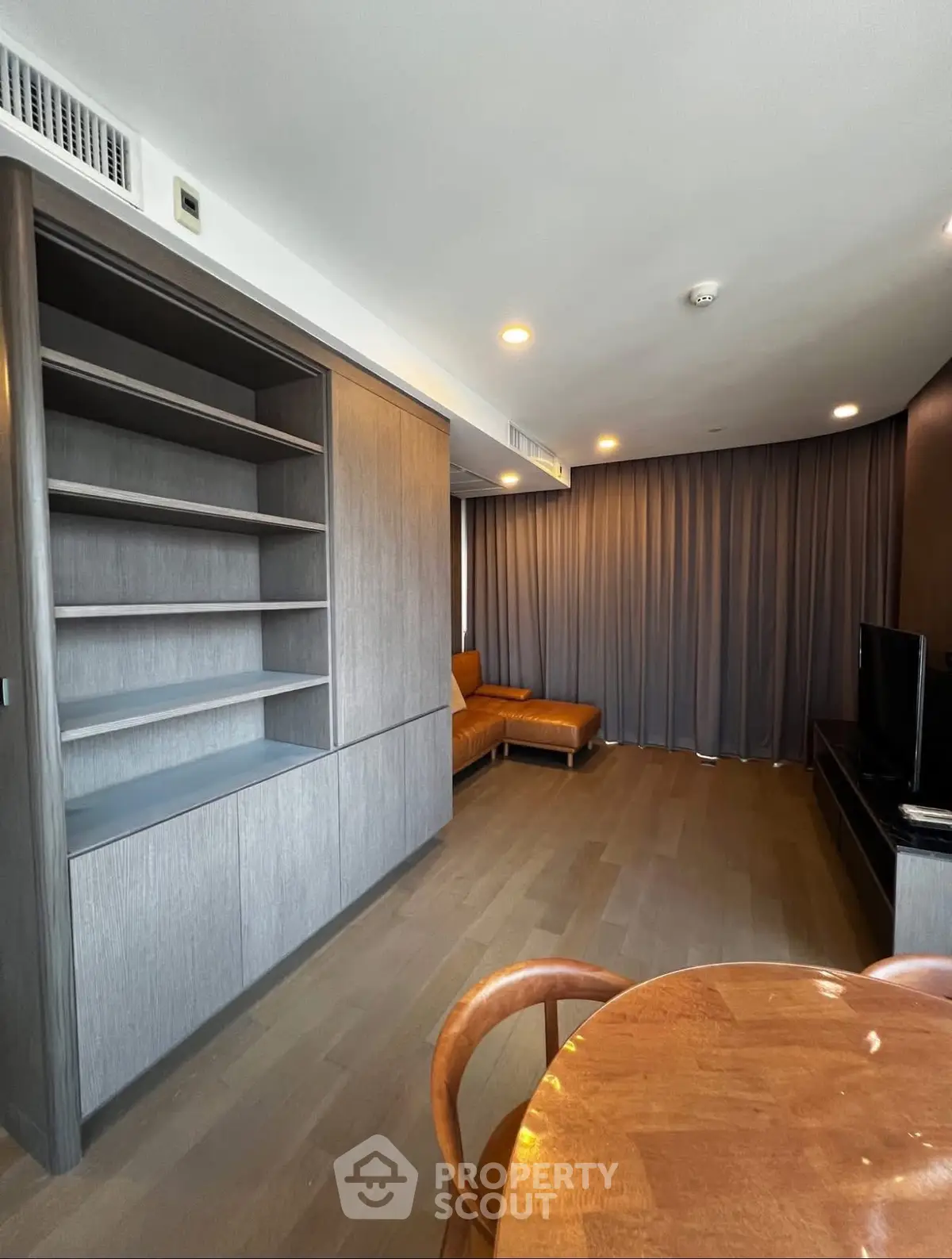 Modern living room with wooden floors and built-in shelving