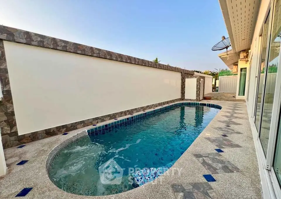 Luxurious private pool with modern design and elegant stone accents in a serene outdoor setting.