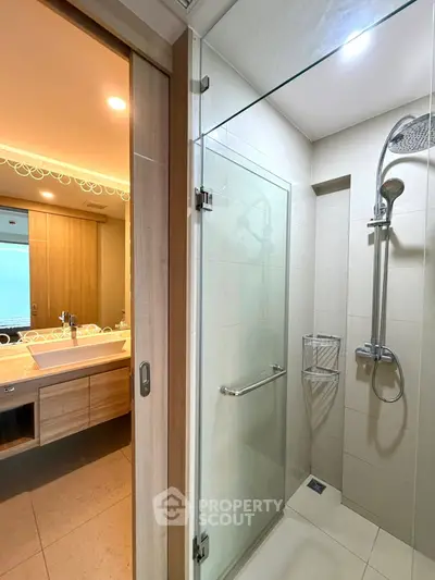 Modern bathroom with glass shower and wooden vanity