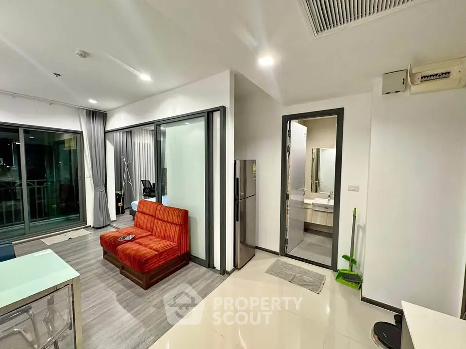 Modern apartment interior with open living area and balcony view