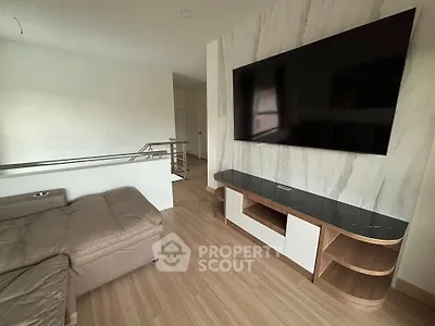 Modern living room with sleek TV setup and stylish wooden flooring
