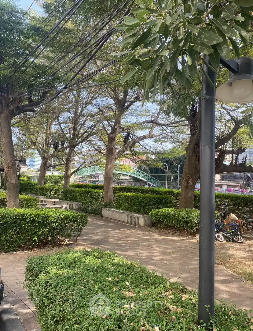 Charming garden view with lush greenery and walking path, perfect for relaxation.