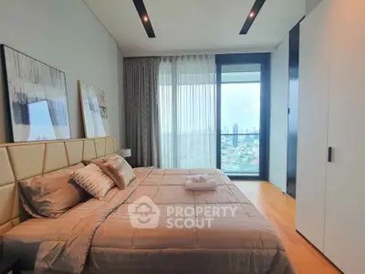 Luxurious bedroom with city view, featuring modern decor and large windows for natural light.