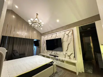 Luxurious modern bedroom with elegant chandelier and marble accent wall