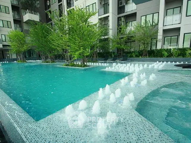 Luxurious apartment complex with stunning pool and lush greenery, perfect for relaxation and leisure.