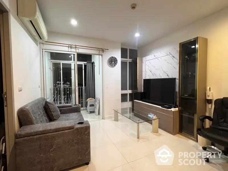 Modern living room with sleek furniture and large TV, featuring a stylish marble accent wall.