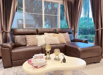Luxurious living room with elegant leather sofa and large window view.