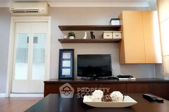 Modern living room with sleek TV setup and stylish shelving