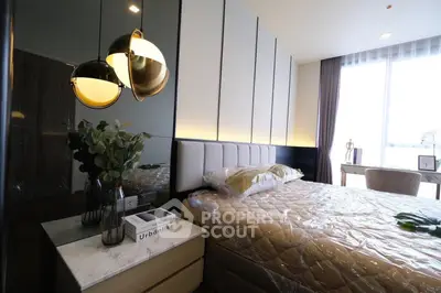 Luxurious modern bedroom with elegant decor and large window for natural light.