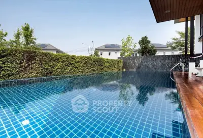 Luxurious outdoor pool with serene surroundings and modern design, perfect for relaxation and leisure.