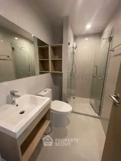 Modern bathroom with glass shower and sleek fixtures