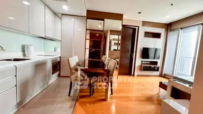 Modern open-layout kitchen and living area with sleek design and natural light.