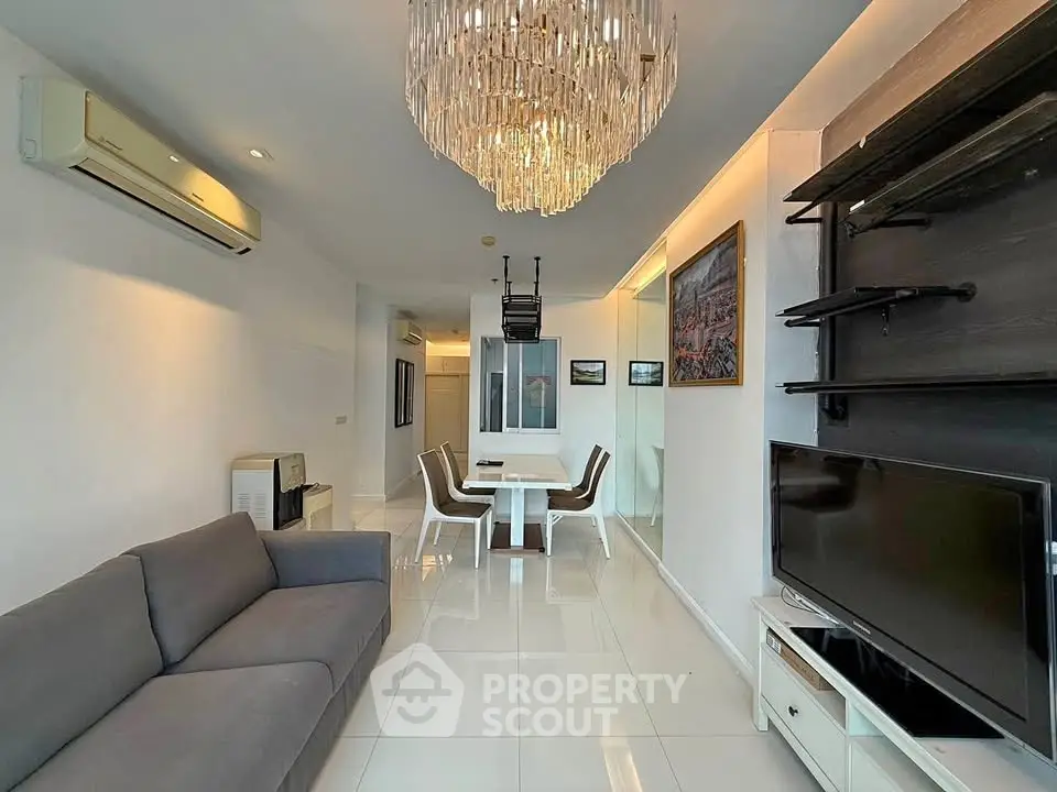 Modern living room with elegant chandelier and sleek furniture