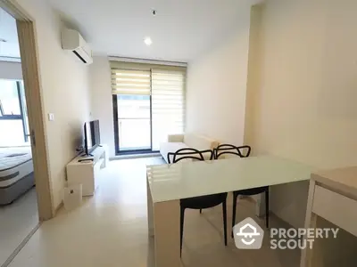 Bright and modern studio apartment with seamless living and dining areas, featuring sleek furniture and ample natural light, perfect for urban living.