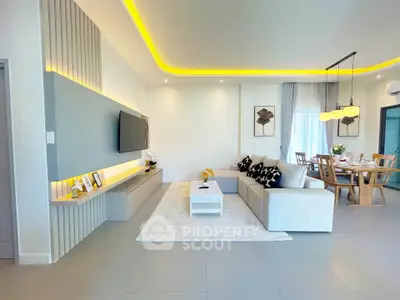 Modern living room with stylish decor and open dining area, featuring ambient lighting and contemporary furniture.