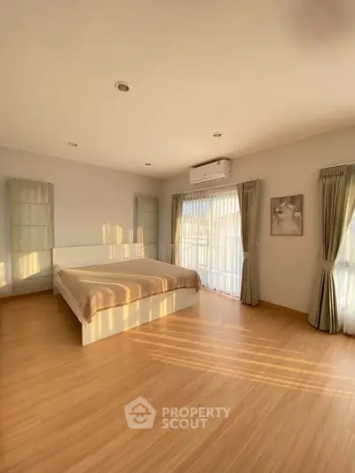 Spacious bedroom with natural light and modern decor